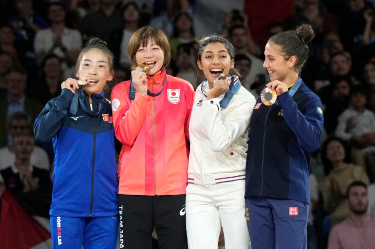 Medal winners, from left, Mongolia's Baasankhuu Bavuudorj, silver, Japan's Natsumi Tsunoda, gold, France's Shirine Boukli, Sweden's Tara Babulfath, bronze, pose on the podium of the women's -48kg event in team judo competition at Champ-de-Mars Arena during the 2024 Summer Olympics, Saturday, July 27, 2024, in Paris, France. (AP Photo/Eugene Hoshiko)