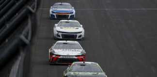 INDIANAPOLIS, INDIANA - JULY 21: Tyler Reddick, driver of the #45 The Beast Unleashed Toyota, Denny Hamlin, driver of the #11 Sport Clips Haircuts Toyota, Chase Elliott, driver of the #9 NAPA Auto Parts Chevrolet, and Kyle Larson, driver of the #5 HendrickCars.com Chevrolet, race during the NASCAR Cup Series Brickyard 400 at Indianapolis Motor Speedway on July 21, 2024 in Indianapolis, Indiana. (Photo by Sean Gardner/Getty Images)