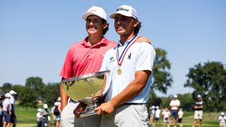 Trevor Gutschewski and his caddie with the US Junior Amateur trophy