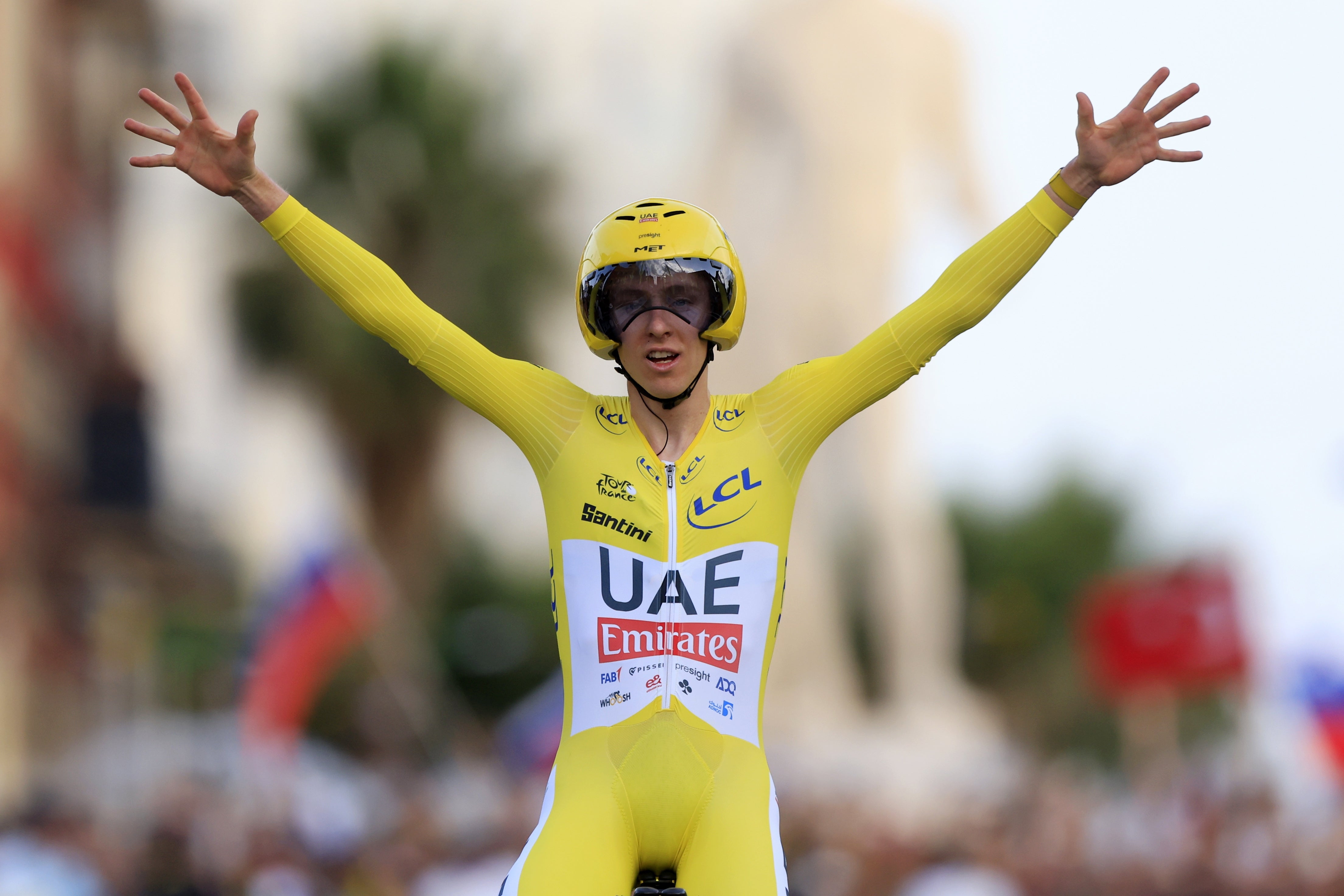 Pogacar celebrates as he crosses the finish line in Nice