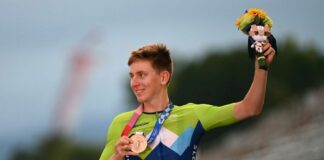 Bronze medallist Slovenias Tadej Pogacar celebrates on the podium during the medal ceremony for the mens cycling road race of the Tokyo 2020 Olympic Games at the Fuji International Speedway in Oyama Japan on July 24 2021 Photo by Greg Baker AFP Photo by GREG BAKERAFP via Getty Images