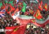 Fans hold Ferrari and Italian flags at Monza 