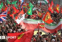 Fans hold Ferrari and Italian flags at Monza 