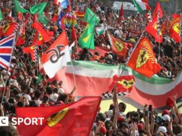 Fans hold Ferrari and Italian flags at Monza 