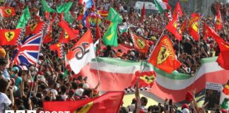 Fans hold Ferrari and Italian flags at Monza 