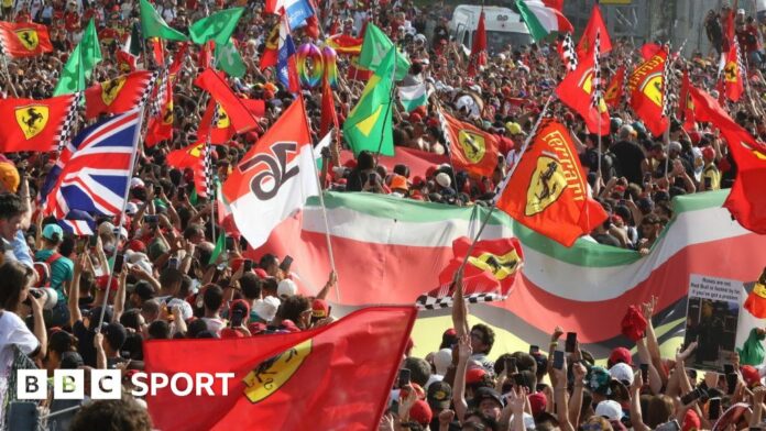 Fans hold Ferrari and Italian flags at Monza 