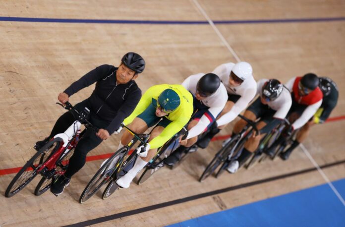 A pacer is seen leading the race prior to the start ahead of Matthew Glaetzer of Team Australia during the men