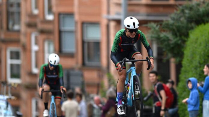 Two women in green cycling kit on bicycles