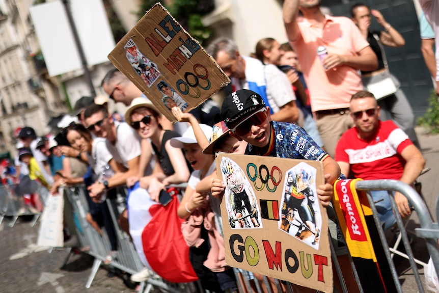 A Belgium fan holds a cardboard sign