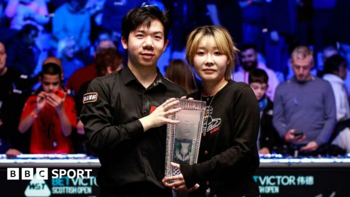 Lei Peifan holds the Stephen Hendry Trophy after his Scottish Open victory