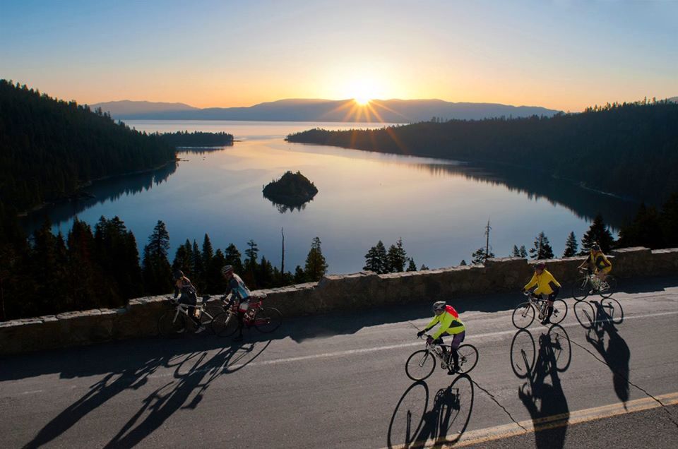 Cyclists ride around the shores of Lake Tahoe