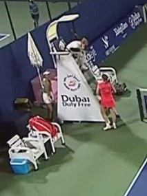 Raducanu hid behind the umpire's chair before being comforted by her opponent Karolina Muchova (in red)
