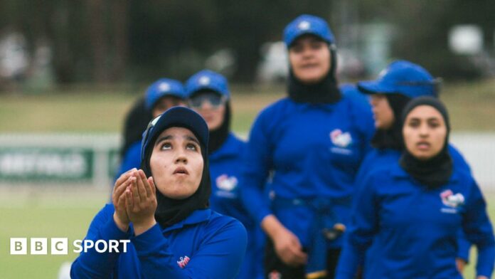 Afghan player Tooba Sarwari looks up with her hands held out during her team's match against Cricket Without Borders