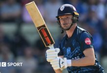 Aneurin Donald watches the ball after playing a shot for Derbyshire