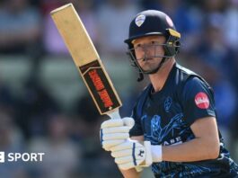 Aneurin Donald watches the ball after playing a shot for Derbyshire