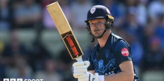 Aneurin Donald watches the ball after playing a shot for Derbyshire