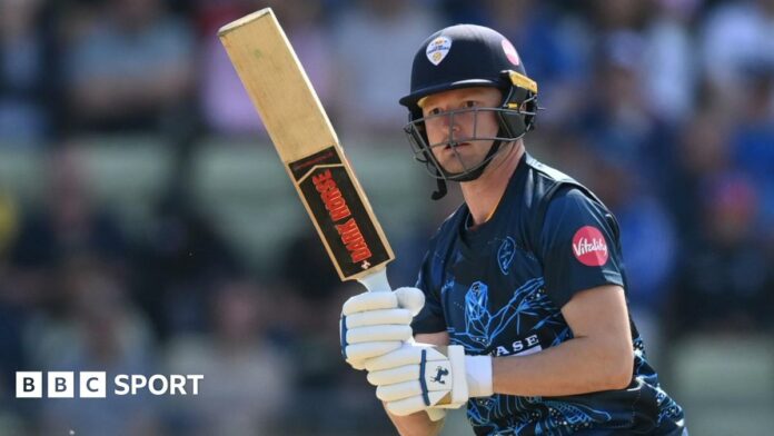 Aneurin Donald watches the ball after playing a shot for Derbyshire