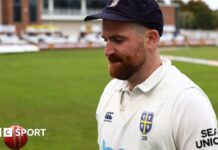 Ben Raine tossing a cricket ball up at Durham's home ground 