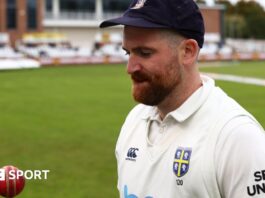 Ben Raine tossing a cricket ball up at Durham's home ground 