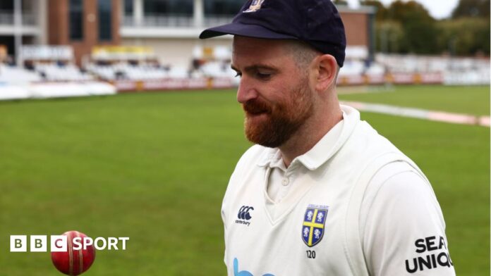 Ben Raine tossing a cricket ball up at Durham's home ground 