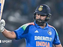 India captain Rohit Sharma raises his bat after reaching a century