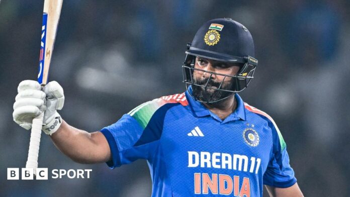 India captain Rohit Sharma raises his bat after reaching a century