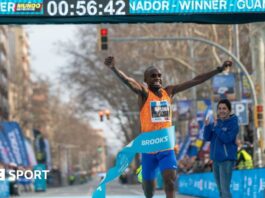 Jacob Kiplimo celebrates after crossing the line