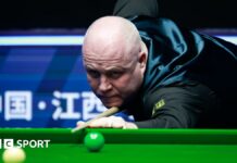 John Higgins focuses on a shot