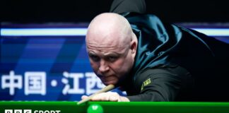 John Higgins focuses on a shot