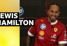 Lewis Hamilton smiles in Ferrari training top