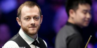 Mark Allen smiles during his Masters match against Si Jiahui