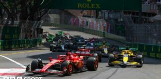 Charles Leclerc of Ferrari leads the field at the first corner of the 2024 Monaco Grand Prix