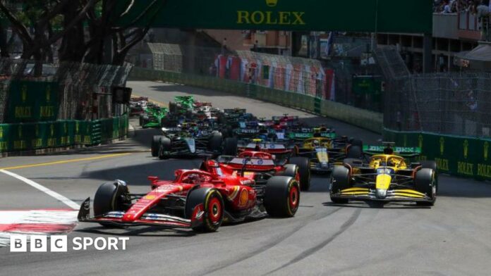 Charles Leclerc of Ferrari leads the field at the first corner of the 2024 Monaco Grand Prix