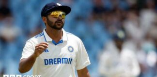 A close up of Shardul Thakur in his sunglasses in the field for India 