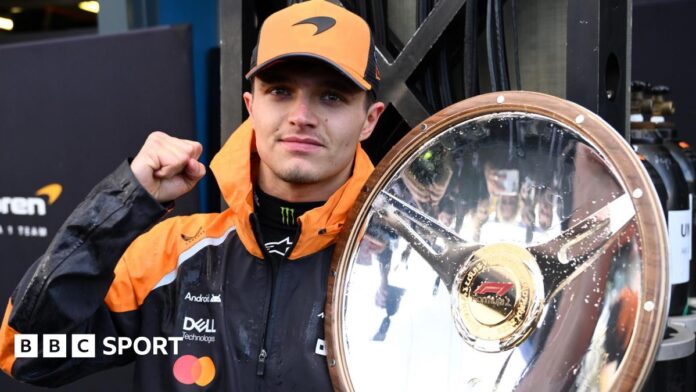 McLaren's Lando Norris holds the winner's trophy for the Australian Grand Prix