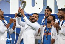 India players wearing their tailored white jackets as they lift the Champions Trophy