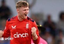 Dan Mousley punches the air in celebration after taking a wicket for England in a white-ball international