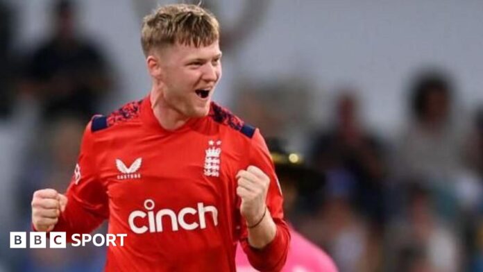 Dan Mousley punches the air in celebration after taking a wicket for England in a white-ball international