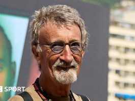 Eddie Jordan smiles while posing for a photograph