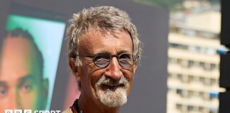 Eddie Jordan smiles while posing for a photograph