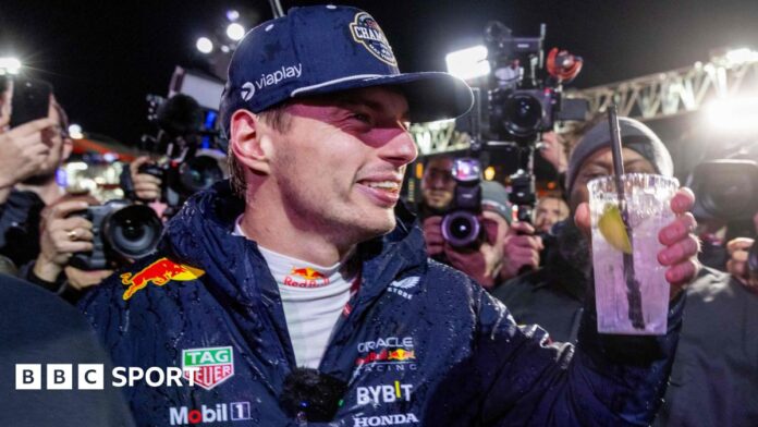 Max Verstappen holds up a drink in celebration after winning the 2024 F1 drivers' championship at the Las Vegas Grand Prix