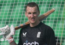 England batter Harry Brook rests his bat on his shoulder in training