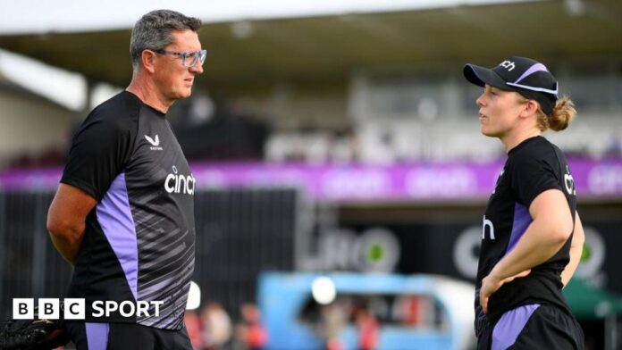 Former England coach Jon Lewis (left) in discussion with captain Heather Knight