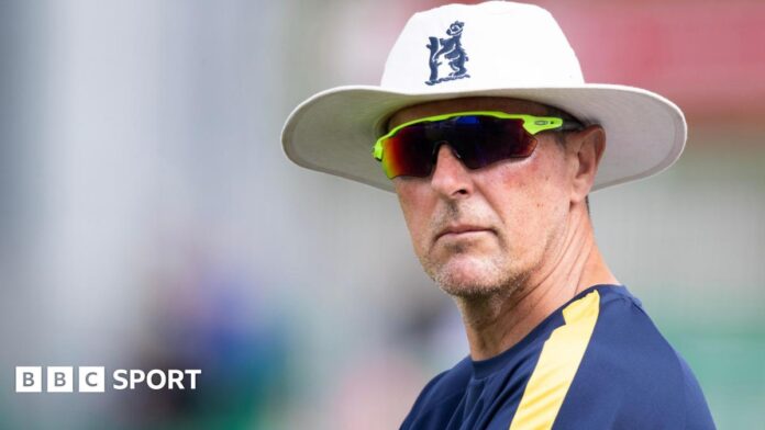 Mark Robinson wearing an England hat and sunglasses