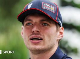 A close-up image of Max Verstappen wearing a Red Bull Racing cap