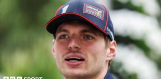 A close-up image of Max Verstappen wearing a Red Bull Racing cap