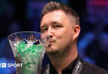 Kyren Wilson kisses the Players Championship trophy after beating Judd Trump