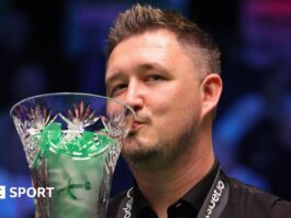 Kyren Wilson kisses the Players Championship trophy after beating Judd Trump