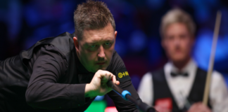 Kyren Wilson plays a shot with the extended rest