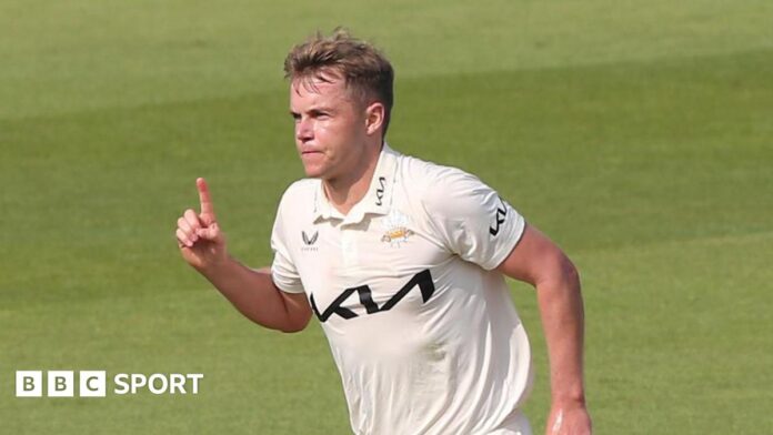 Sam Curran with his finger in the air after taking a wicket for Surrey